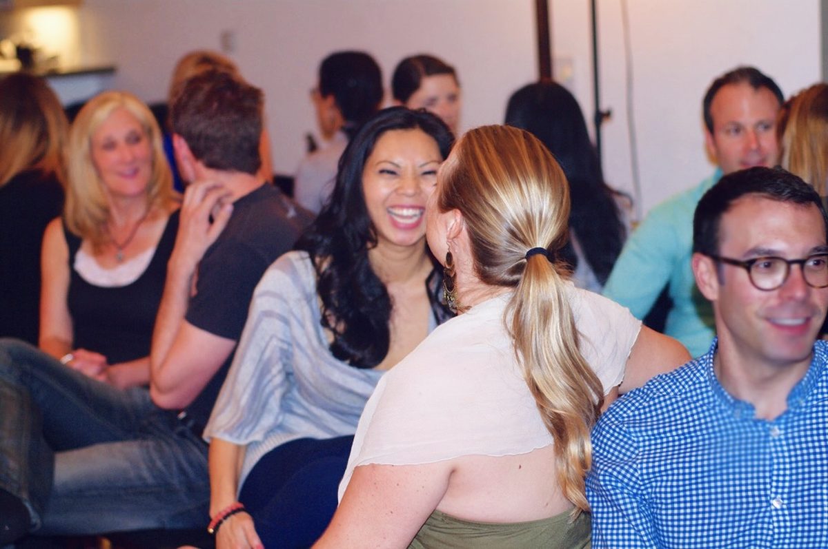 People engaged in lively conversation at a workshop gathering, representing contact Davon Method community events.